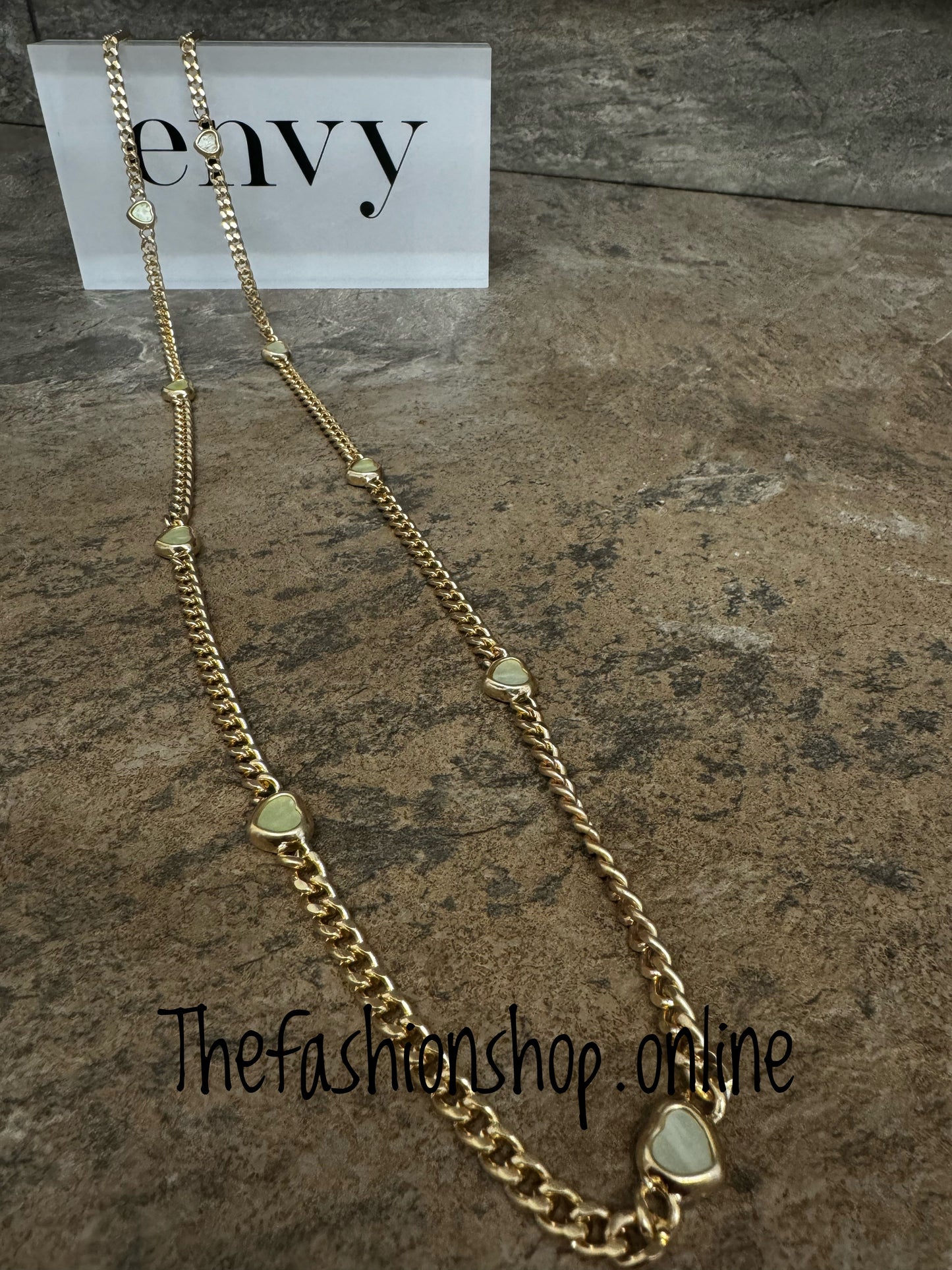 Envy long gold curb necklace with small pale green hearts