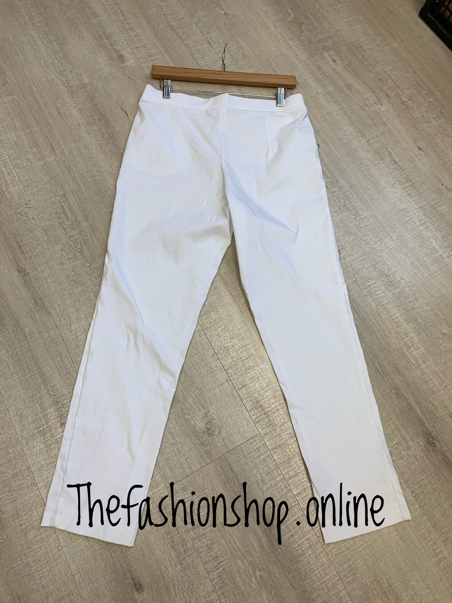 White stretchy sized trousers with button detail sizes 10-22