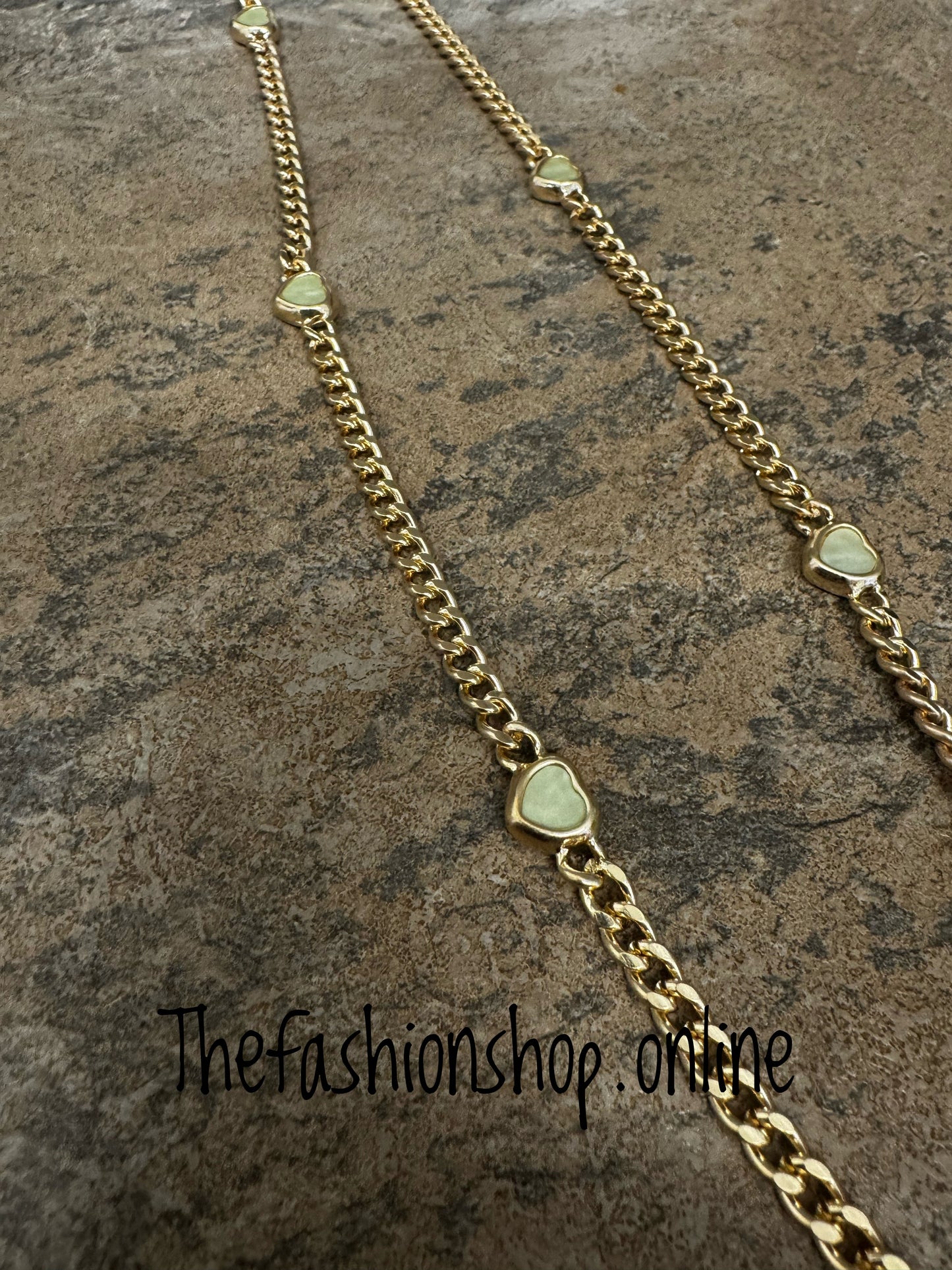 Envy long gold curb necklace with small pale green hearts