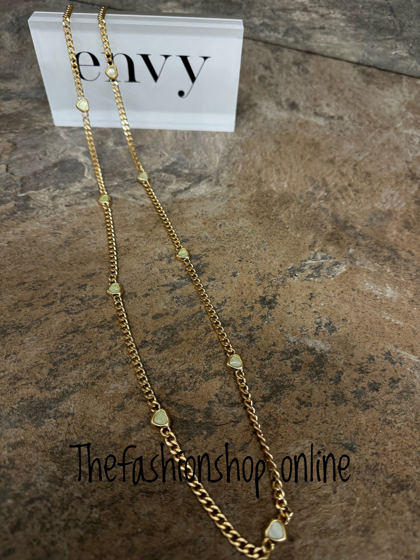 Envy long gold curb necklace with small pale green hearts