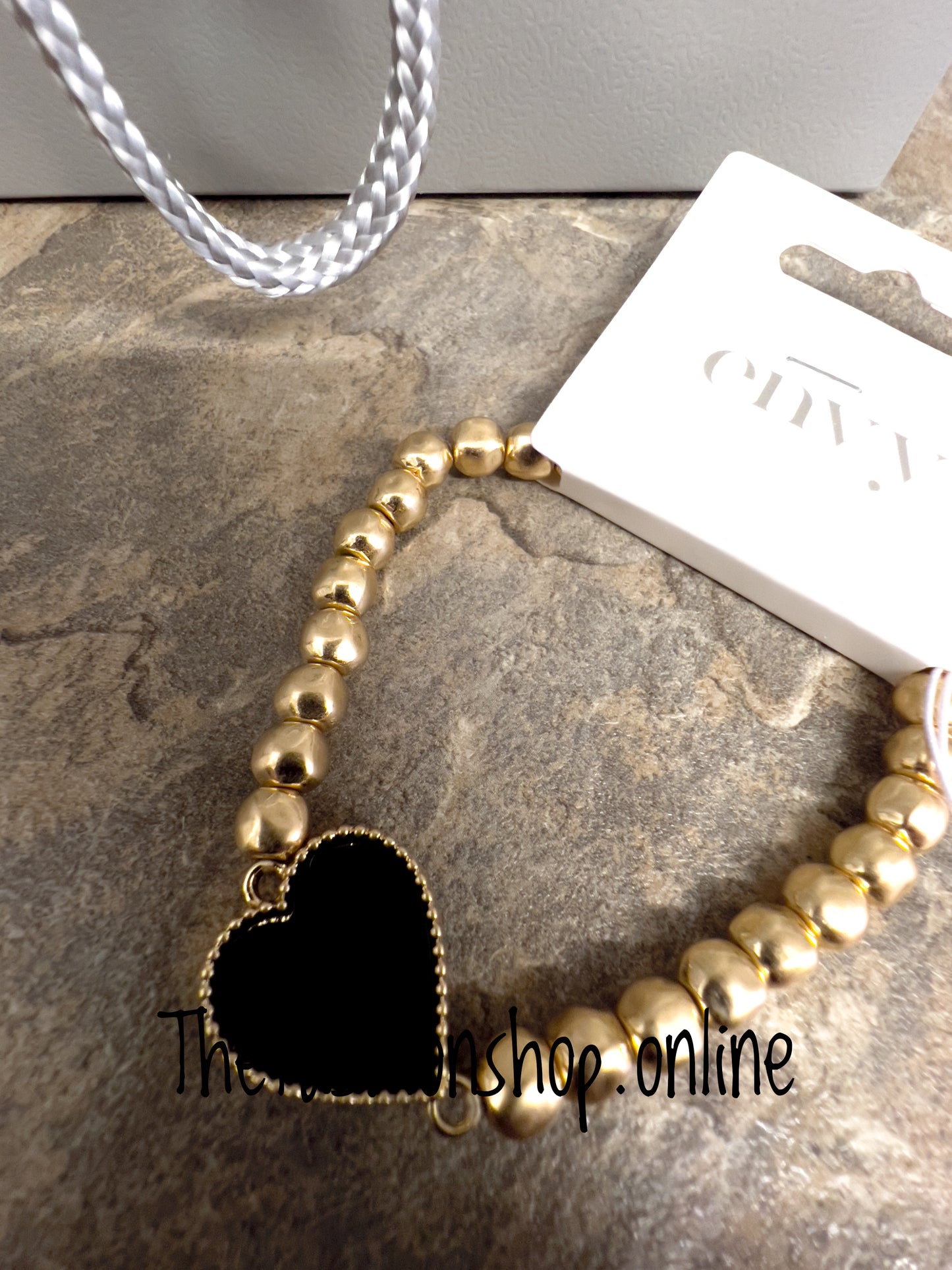 Envy gold beaded bracelet with black heart