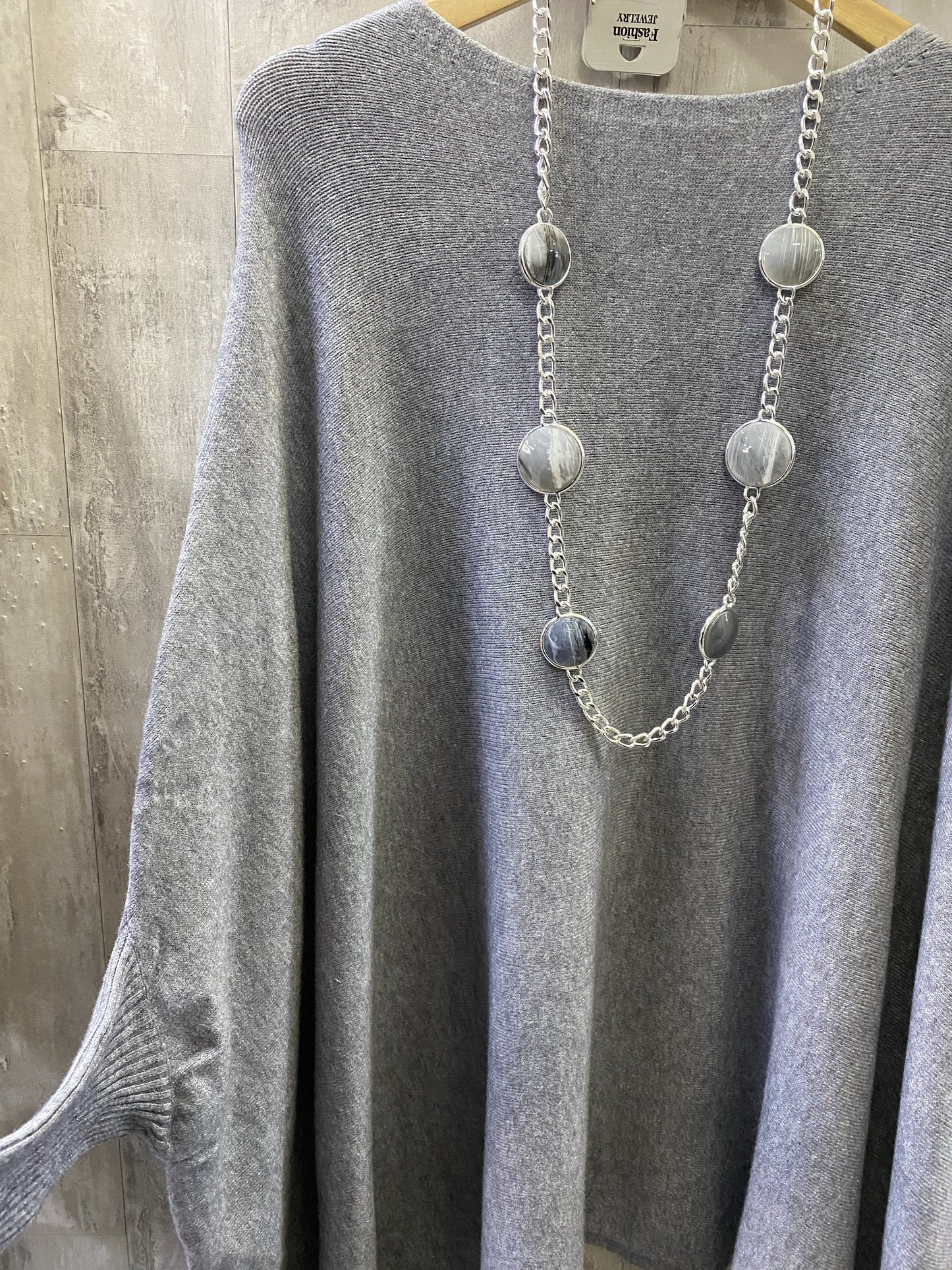 Grey poncho with sleeves in