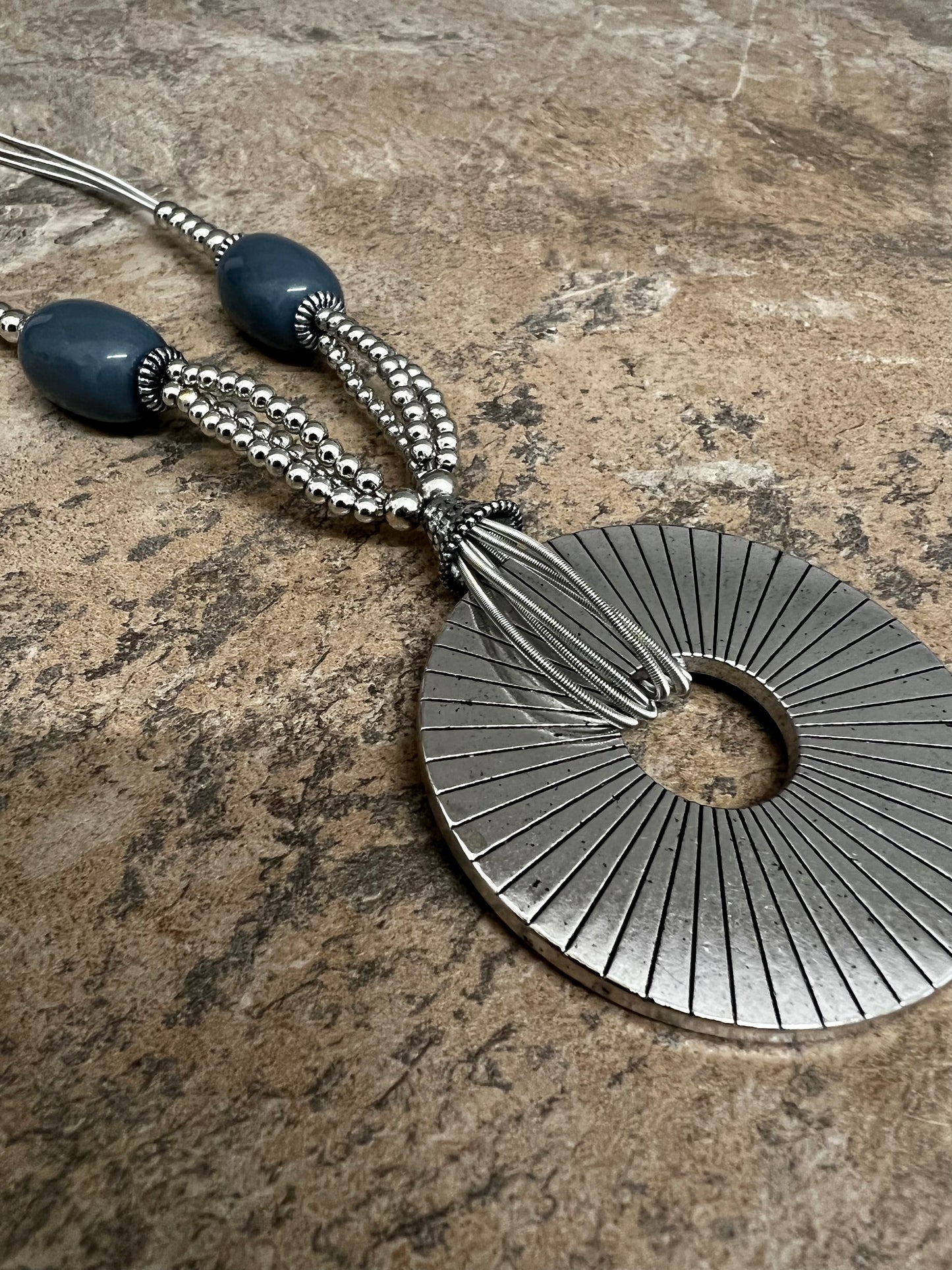 Grey bead and silver sundial necklace